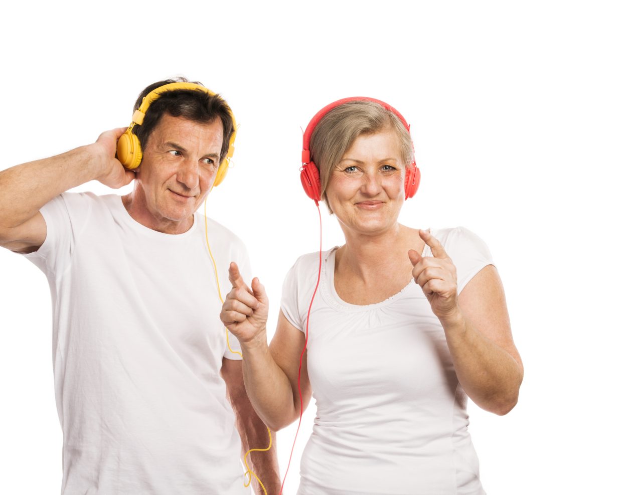 Senior couple listening to music with headphones, isolated on white