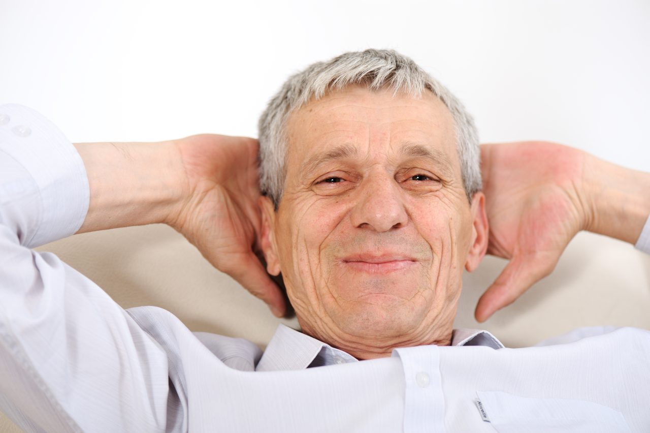 Happy relaxed elderly man at home