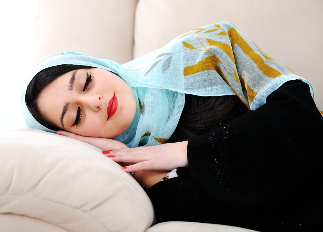 Arabic woman sleeping on sofa