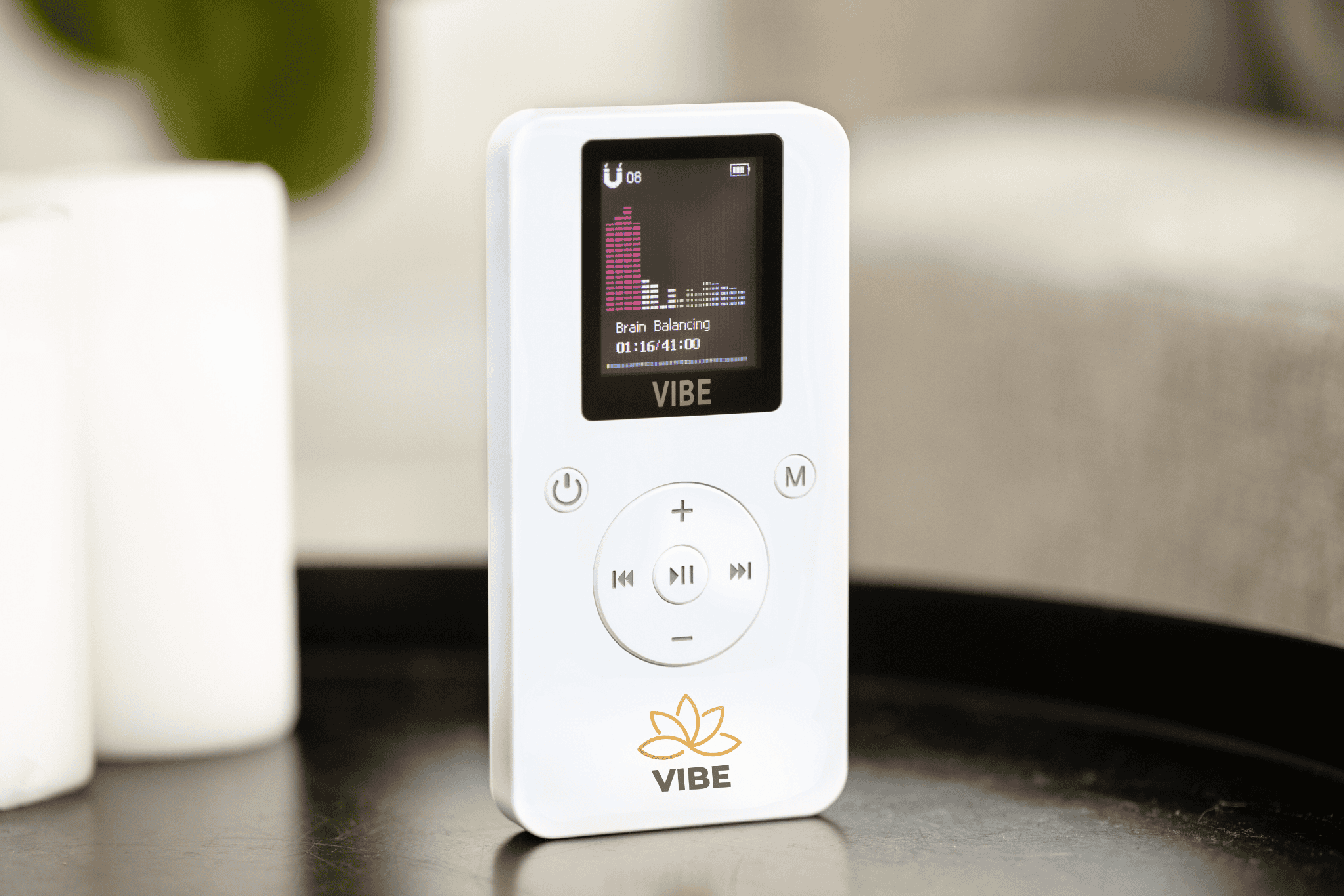 The VIBE pocket PEMF device resting in an open hand.