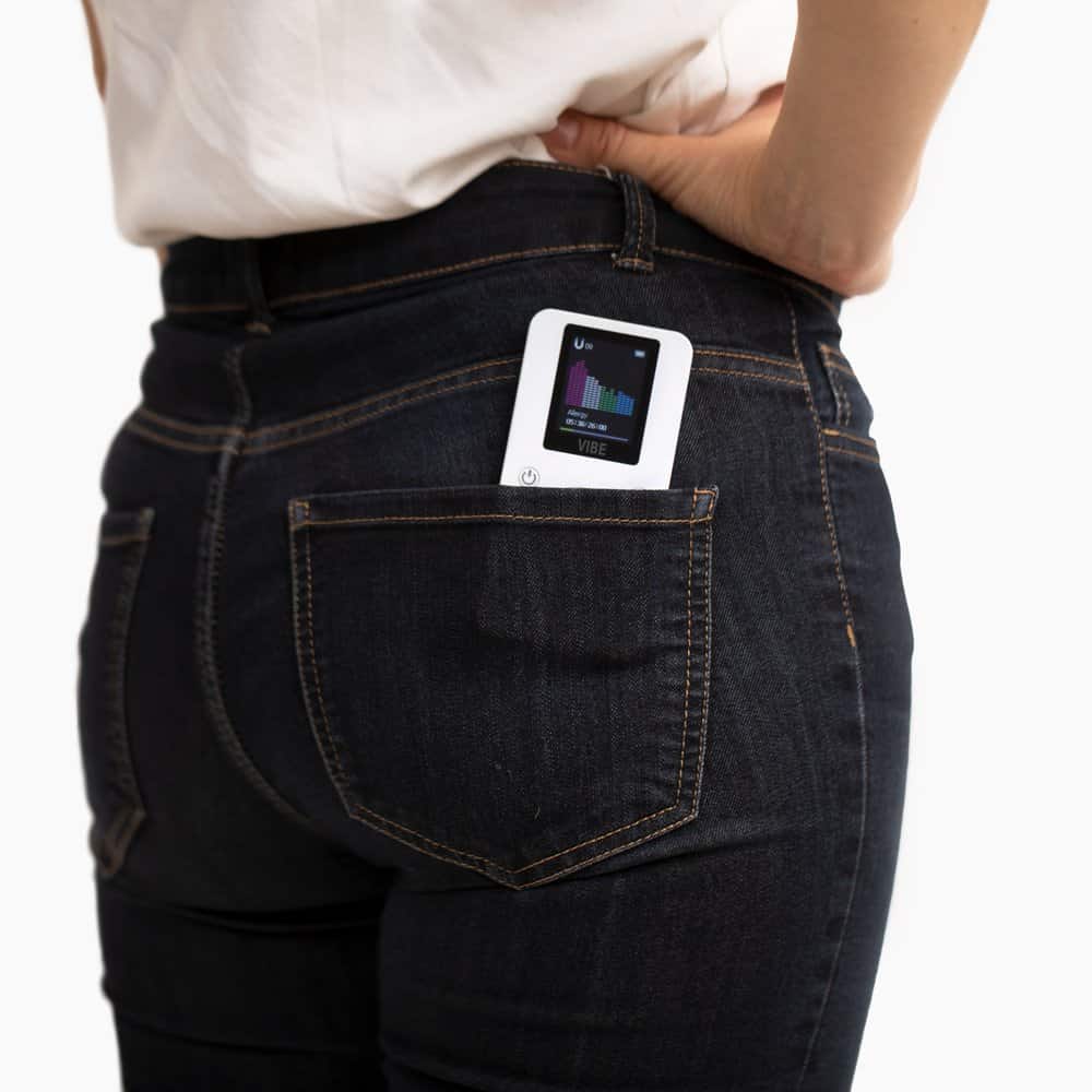 The VIBE tucked in the back pocket of a pair of jeans
